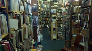 Books lay haphazardly on their shelves, jumping into the hands of their future readers. 