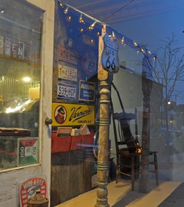 Peninsula Trading's large front window, adorned with vintage signs.